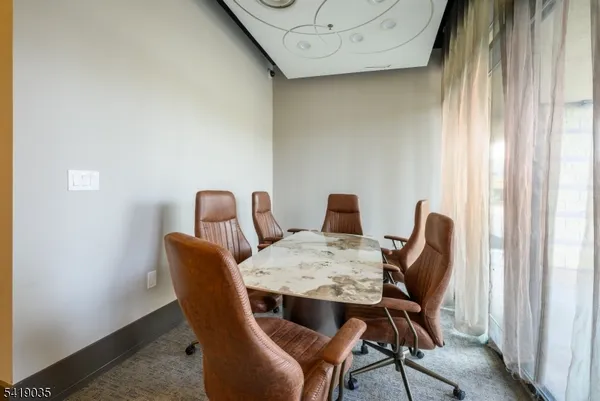 a view of a dining room with furniture and window