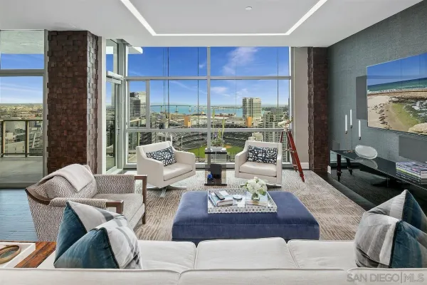 a living room with furniture and a floor to ceiling window