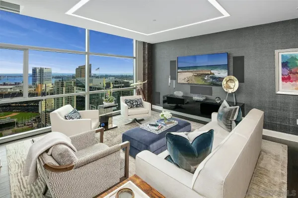 a living room with patio furniture and a large window