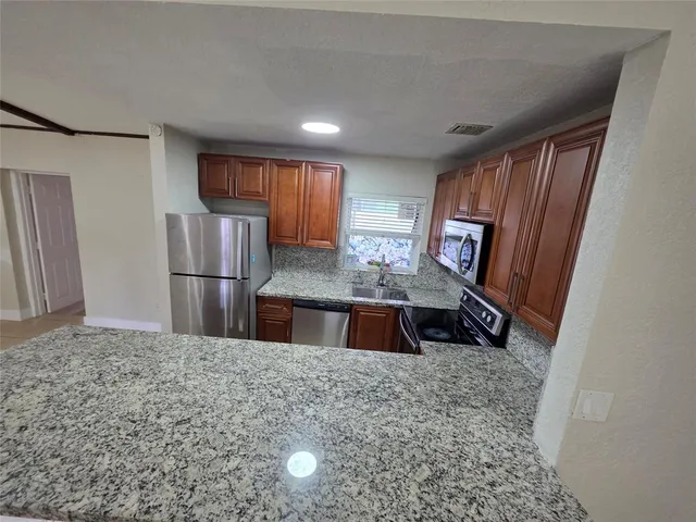 a kitchen with stainless steel appliances a refrigerator and a sink