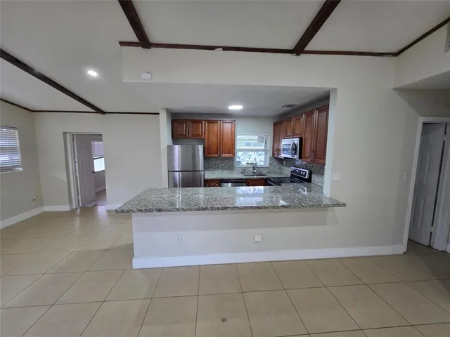a view of a kitchen with a sink and cabinets