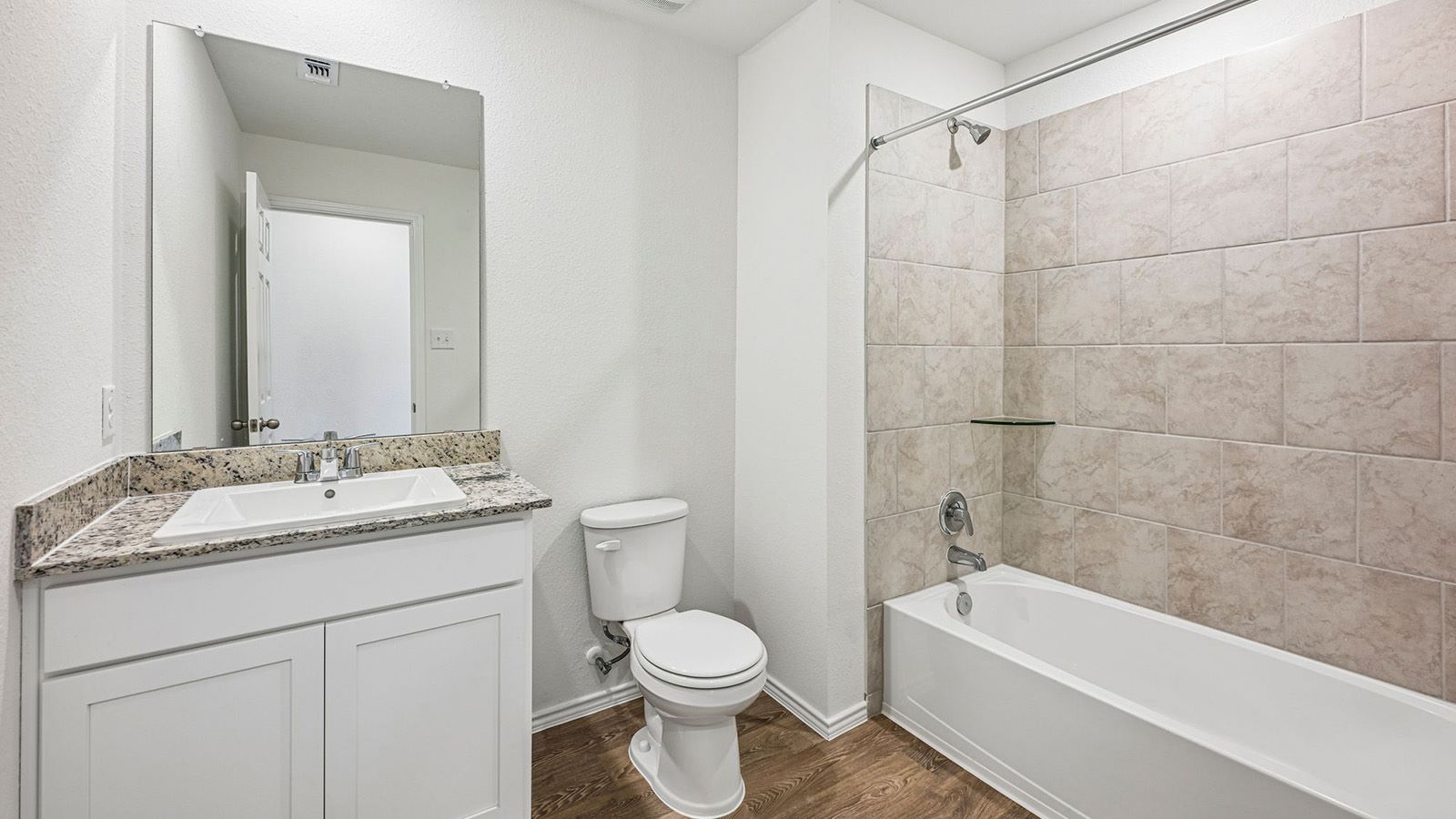369 Old Stage Coach Road Jarrell, TX 76537 - Photo 20 of 25 A classic tiled shower surround and granite-topped vanity anchor this comfortable bathroom.