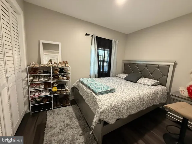 a bedroom with a bed and a dresser