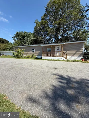 a backyard of a house with basket ball court