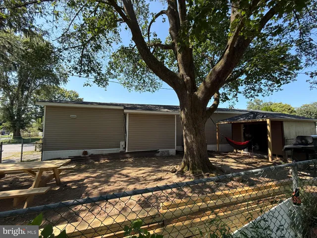 a yellow house with trees in front of it