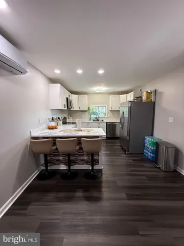 a room with stainless steel appliances furniture and kitchen view