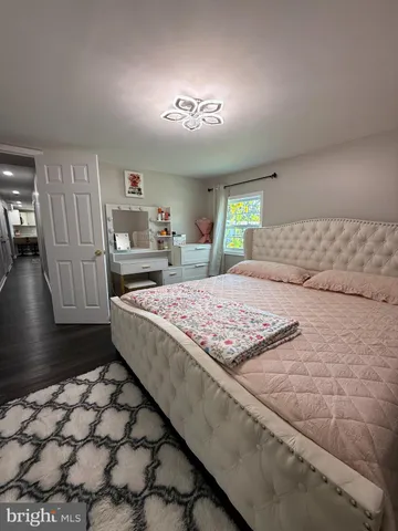 a bedroom with a large bed and a couch