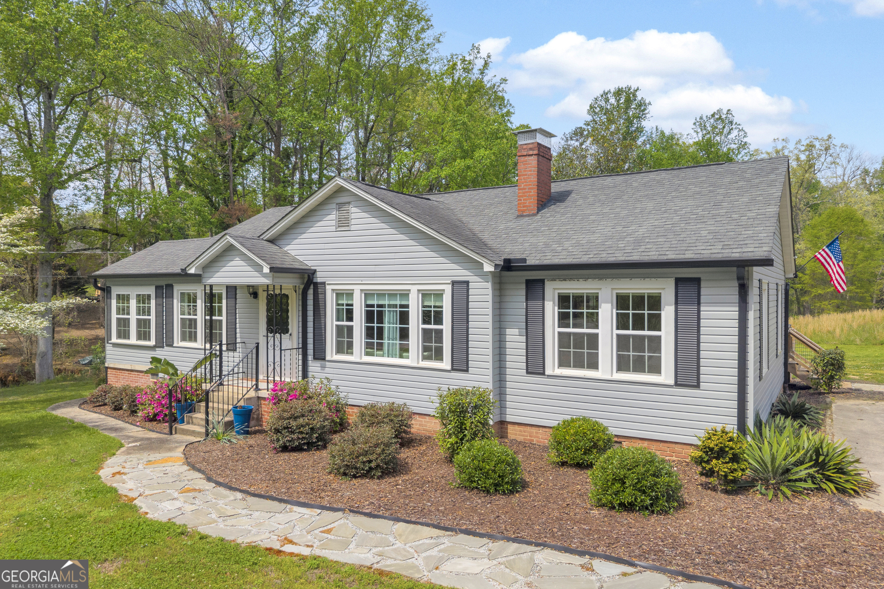 a front view of a house with garden