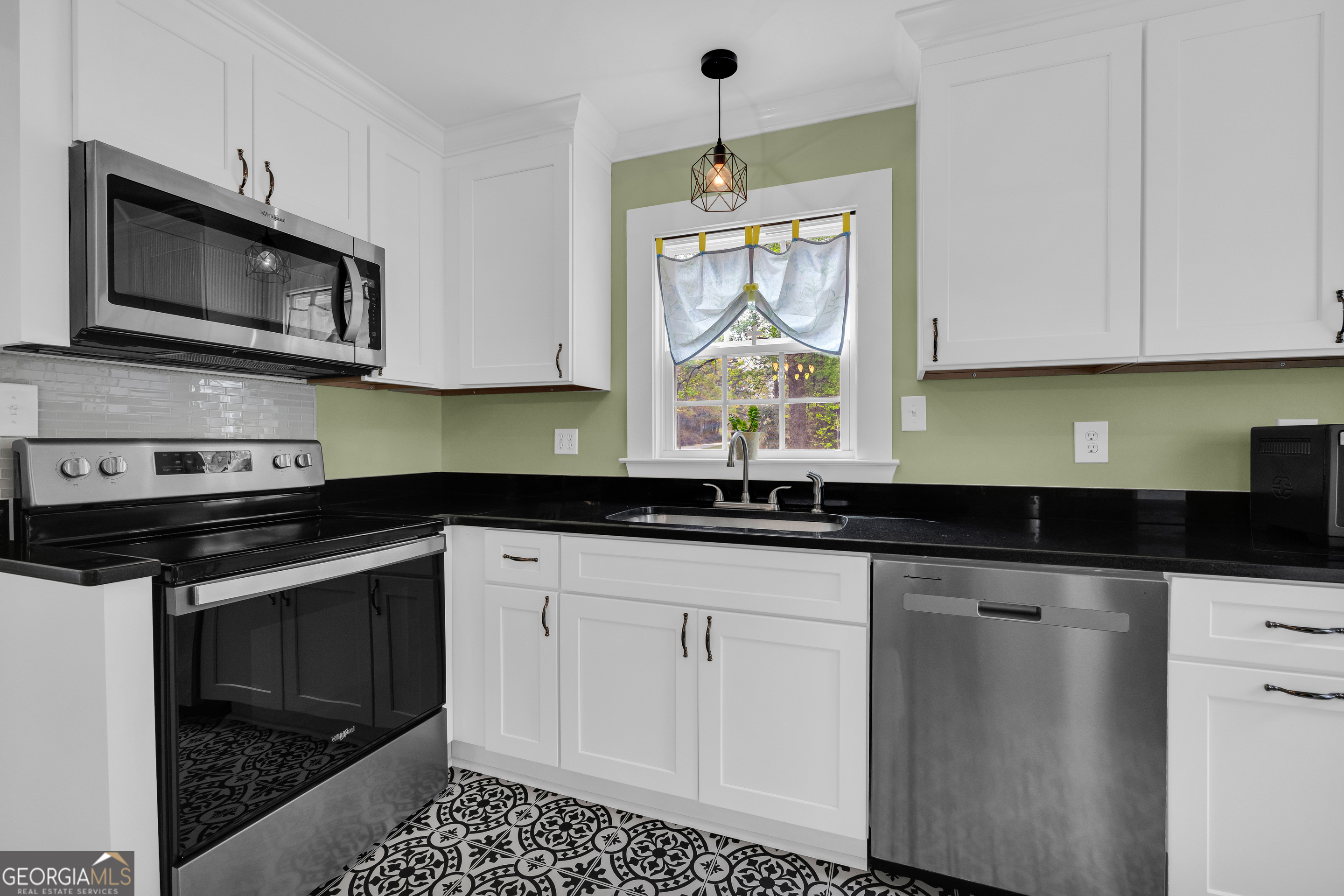 261 Oak Valley Road Toccoa, GA 30577 - Photo 14 of 52 a kitchen with granite countertop white cabinets stainless steel appliances and a window