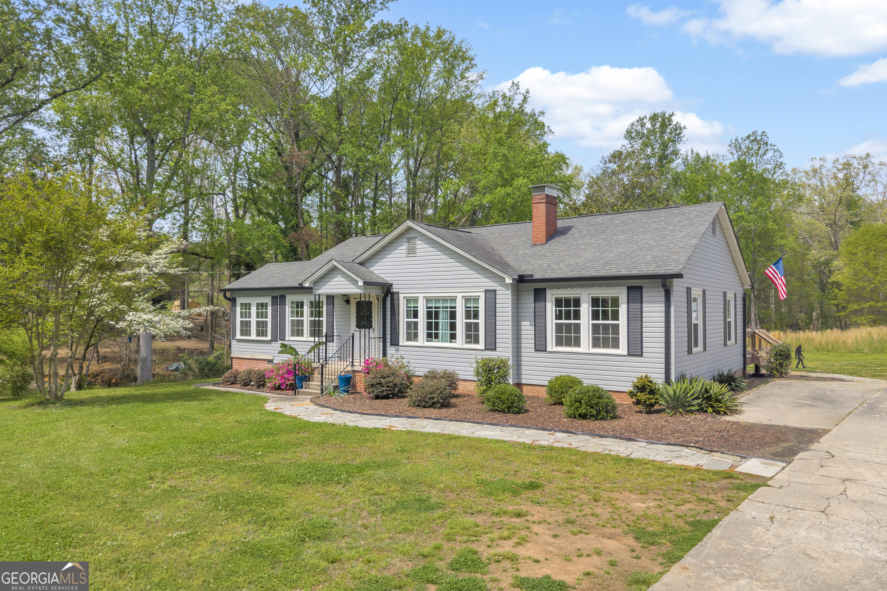 261 Oak Valley Road Toccoa, GA 30577 - Photo 3 of 52 a front view of a house with garden