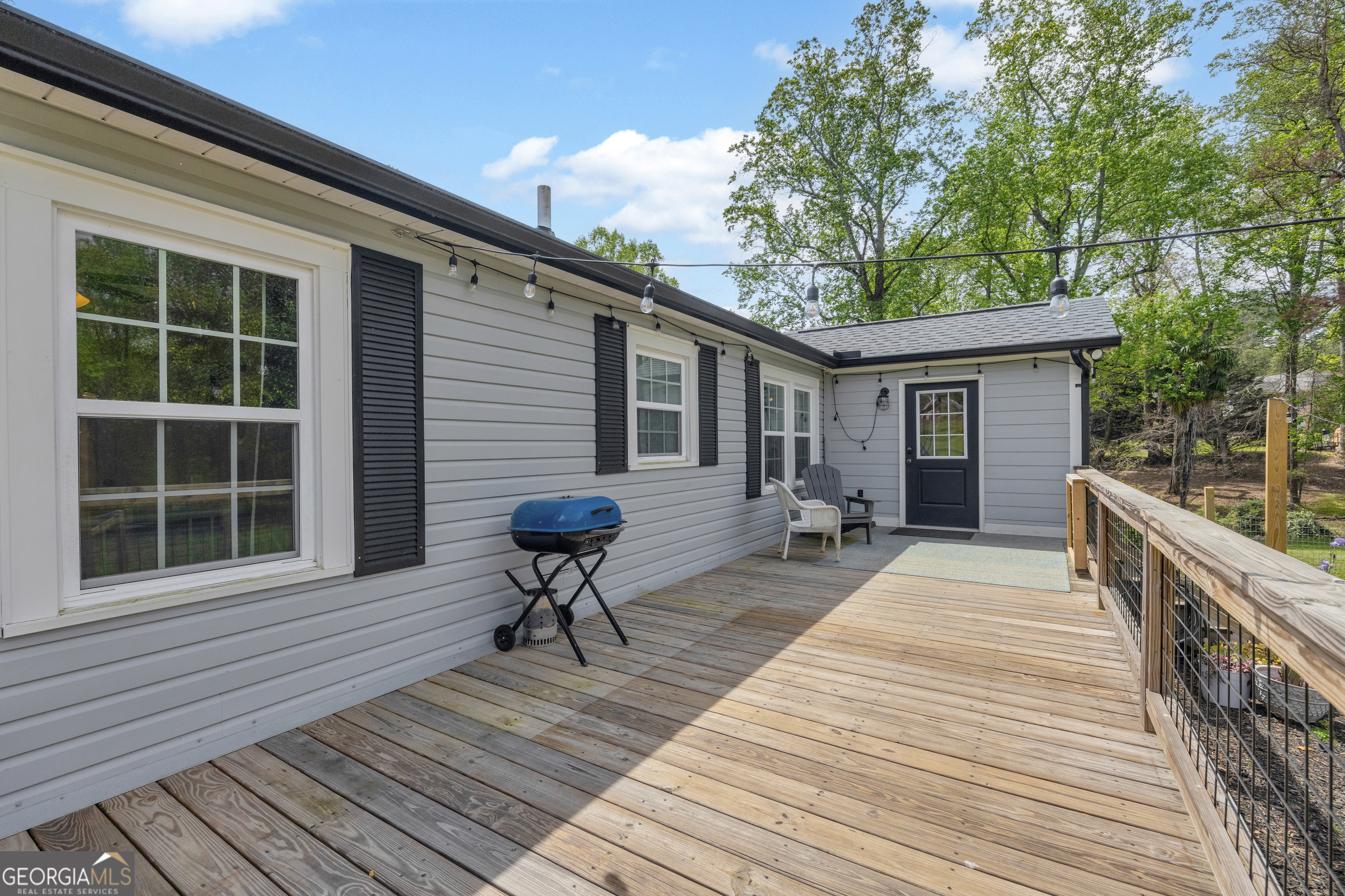 261 Oak Valley Road Toccoa, GA 30577 - Photo 34 of 52 a house with wooden floor and outdoor seating