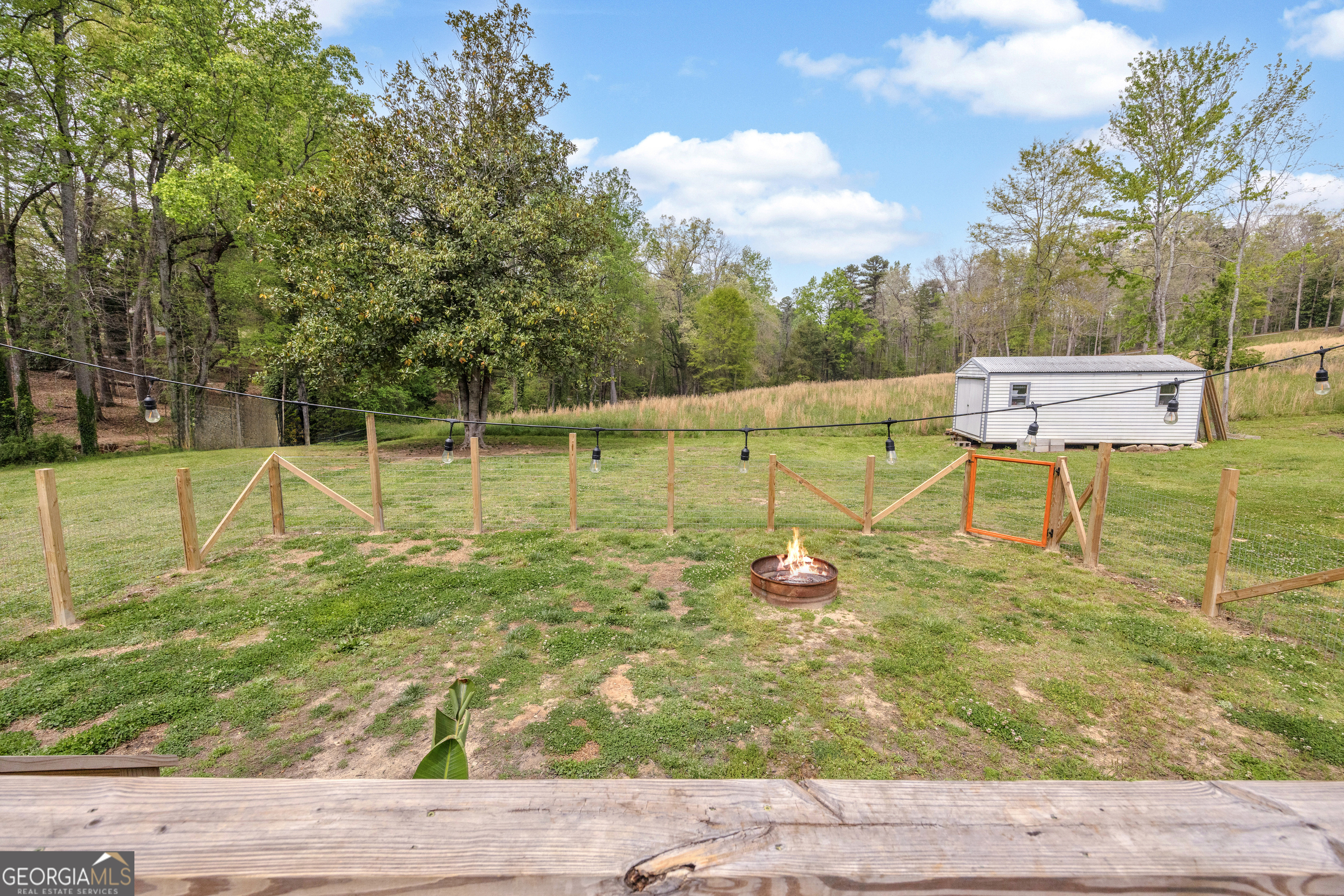 261 Oak Valley Road Toccoa, GA 30577 - Photo 41 of 52 a backyard of a house with table and chairs