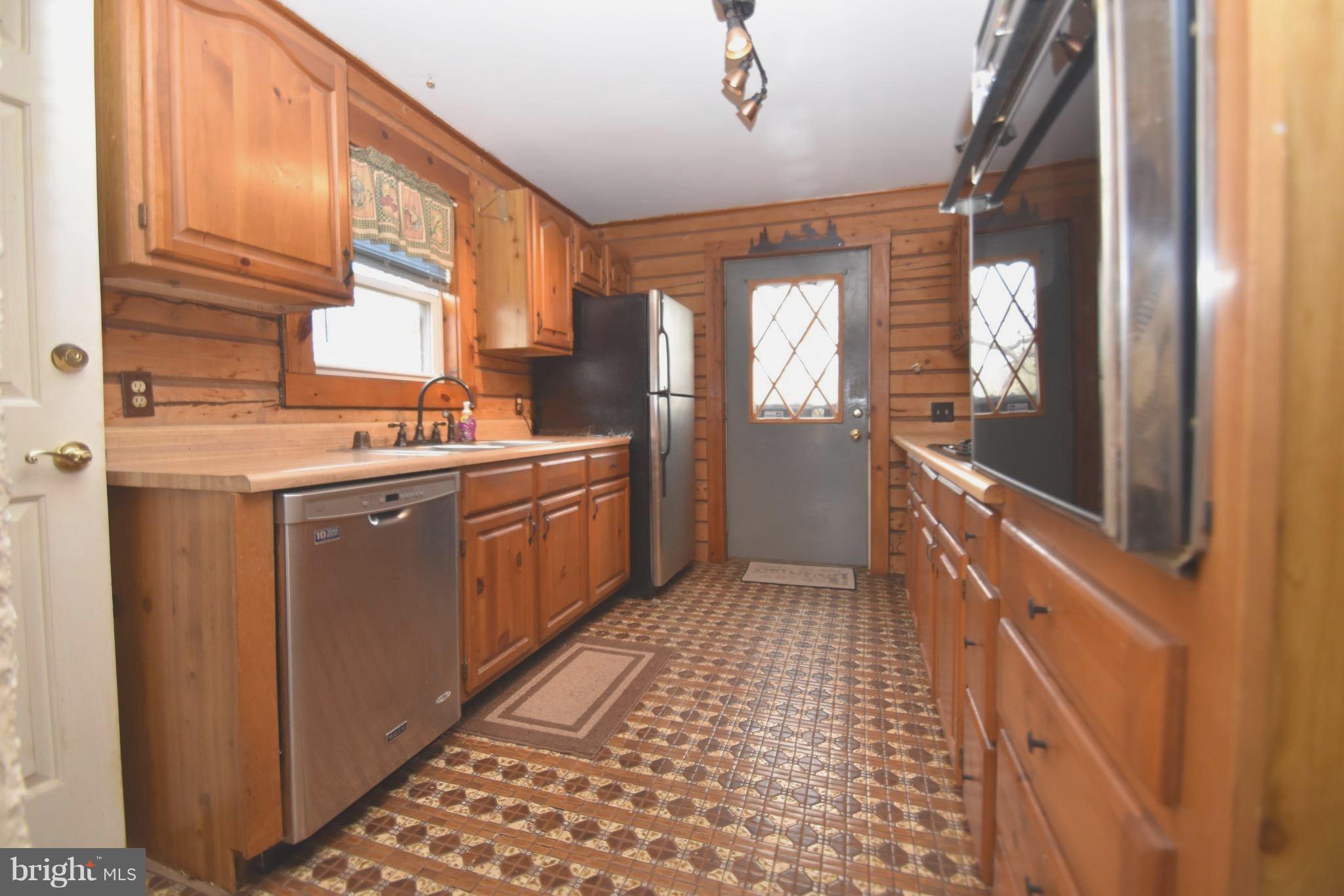 5638 Prince George Street Baltimore, MD 21207 - Photo 6 of 15 a kitchen with a sink a counter top space and cabinets