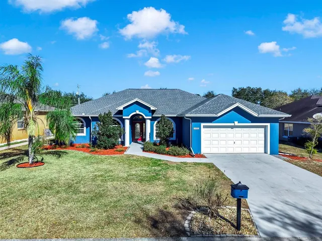 a front view of a house with swing and slide