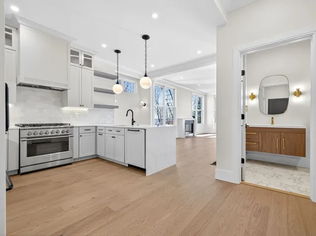 a large kitchen with a stove and a sink