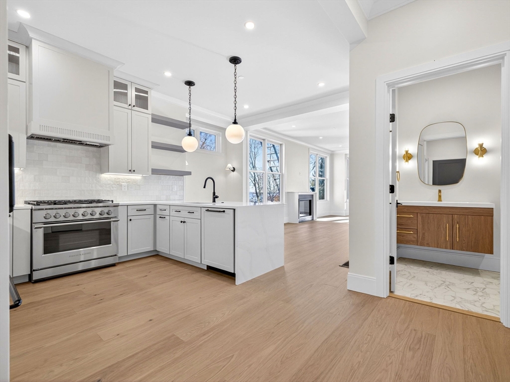 a large kitchen with a stove and a sink