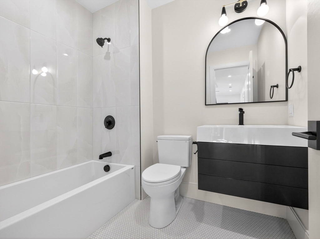 427 East 6th Street, Unit 1 Boston, MA 02127 - Photo 18 of 30 a bathroom with a sink a toilet and a mirror