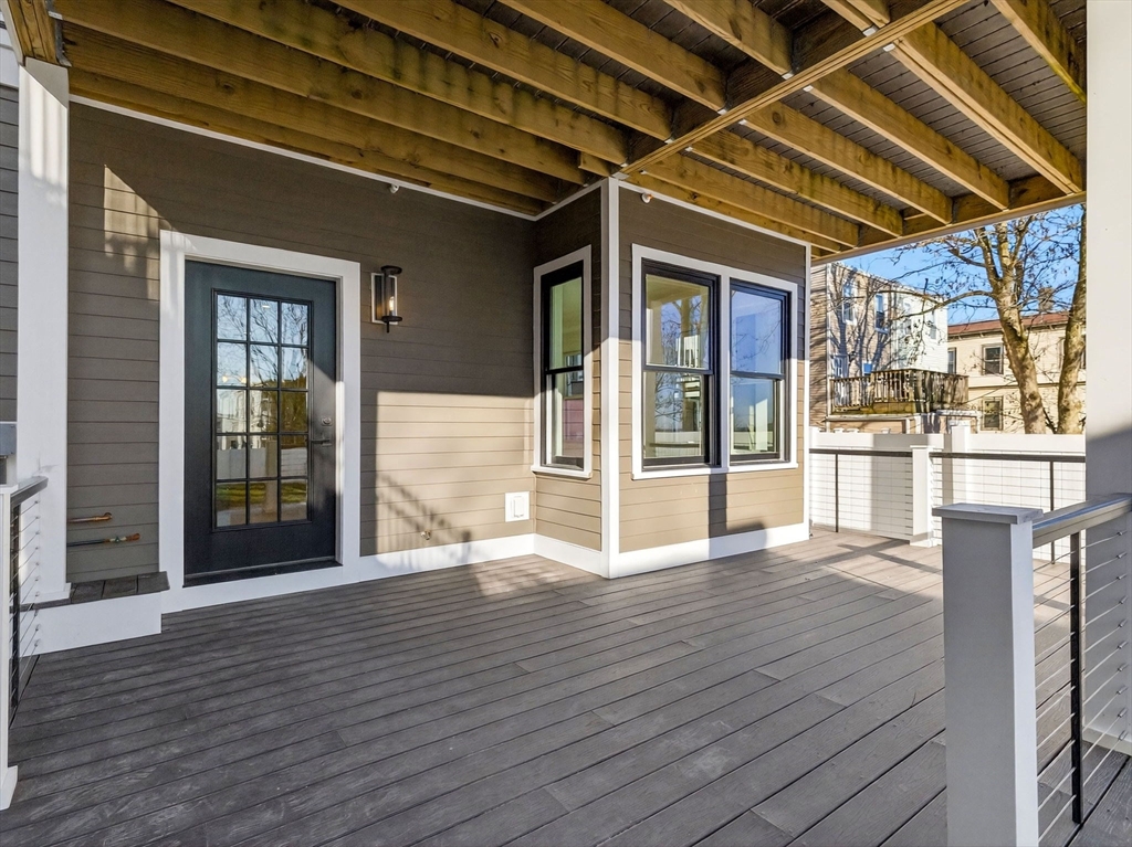 427 East 6th Street, Unit 1 Boston, MA 02127 - Photo 21 of 30 a view of an empty room with wooden floor and windows