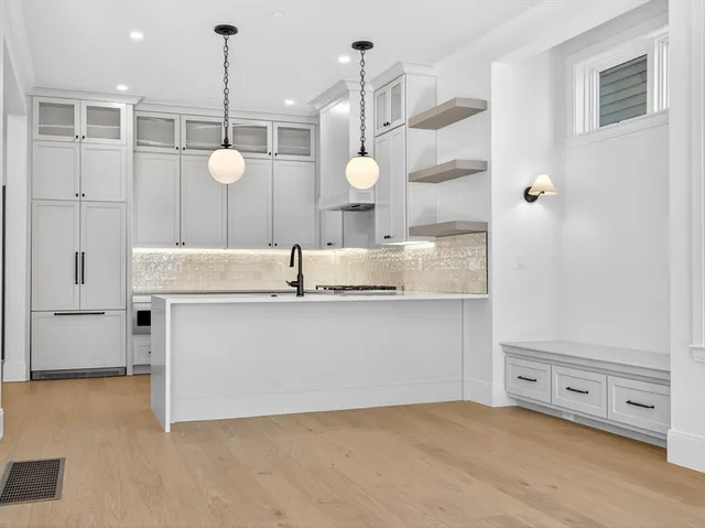 a view of a kitchen with a sink a refrigerator and a stove