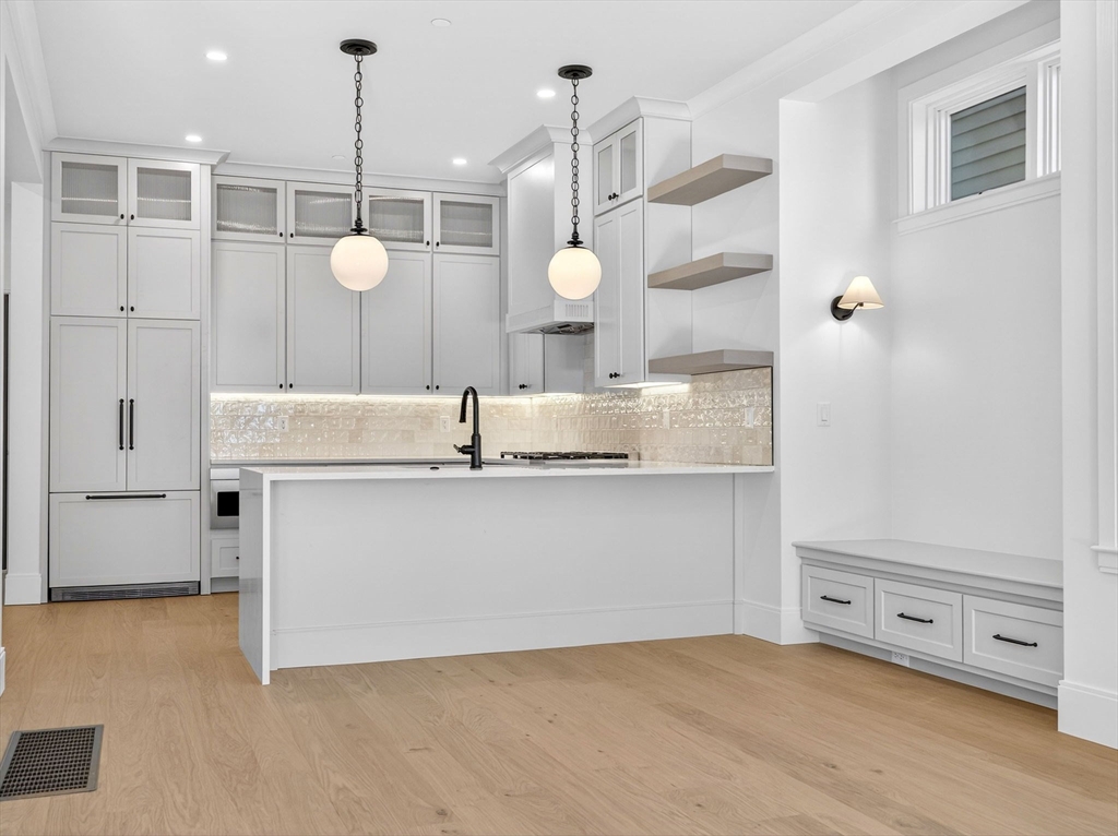 427 East 6th Street, Unit 1 Boston, MA 02127 - Photo 4 of 30 a view of a kitchen with a sink a refrigerator and a stove