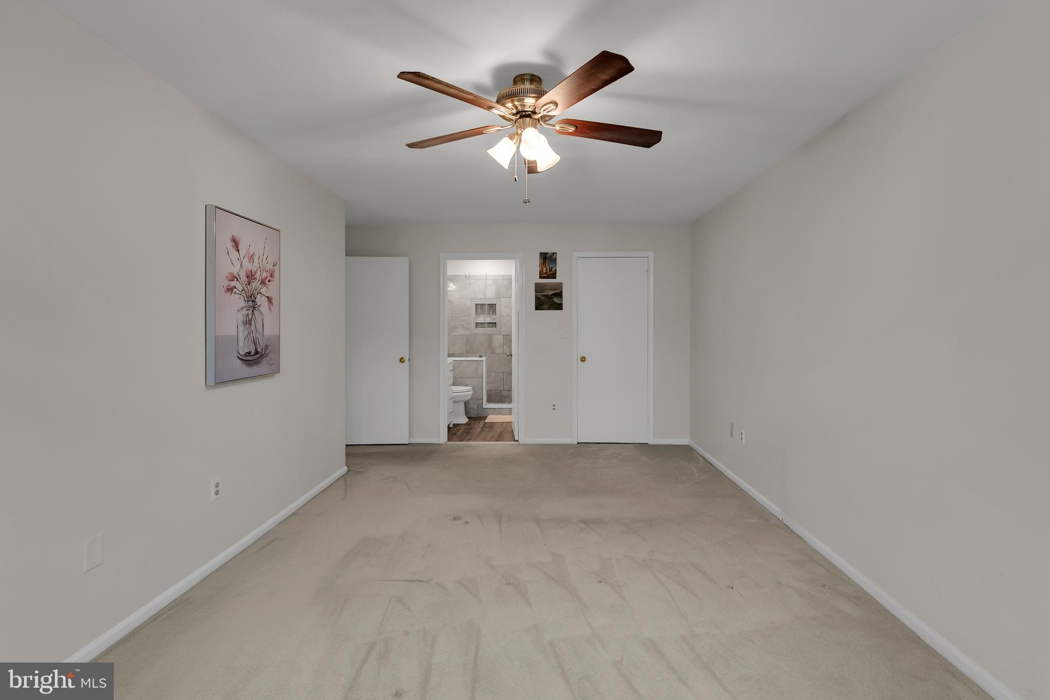 5 Mill Run West, Unit 5 Hightstown, NJ 08520 - Photo 16 of 26 an empty room with closet and ceiling fan