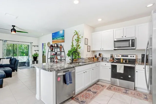 a kitchen with stainless steel appliances granite countertop a sink and a stove