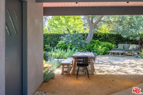 a view of backyard with outdoor seating and green space