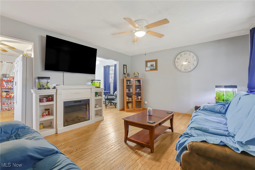 232 McGill Road Vincent, OH 45784 - Photo 8 of 49 Living room with ceiling fan, a glass covered fireplace, and light wood-style floors