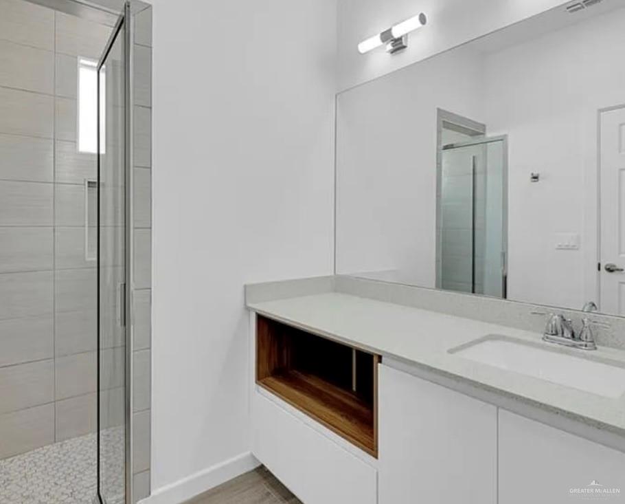 1403 Marcela Drive, Unit 1 Weslaco, TX 78599 - Photo 12 of 13 Bathroom featuring a shower stall and vanity