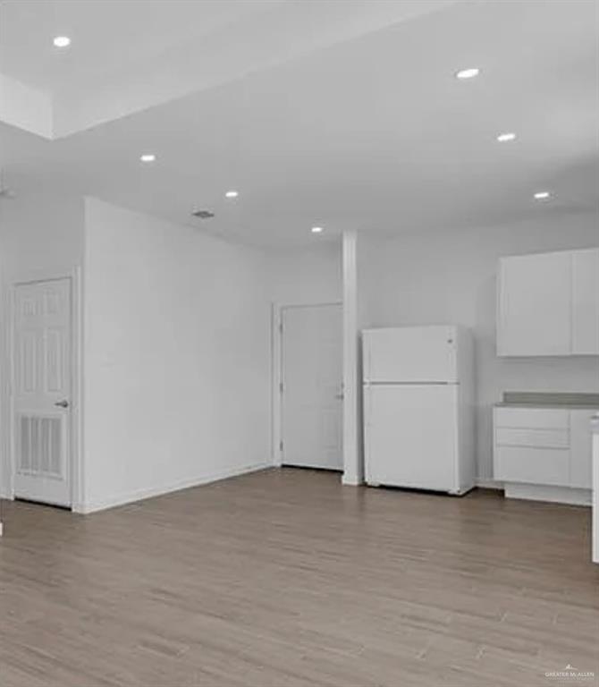 1403 Marcela Drive, Unit 1 Weslaco, TX 78599 - Photo 8 of 13 Basement featuring freestanding refrigerator, light wood-style floors, and recessed lighting