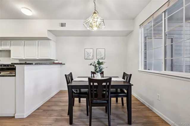 a view of a dining room with furniture window and wooden floor