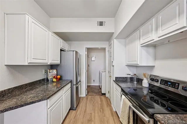 a kitchen with stainless steel appliances granite countertop a stove and a sink
