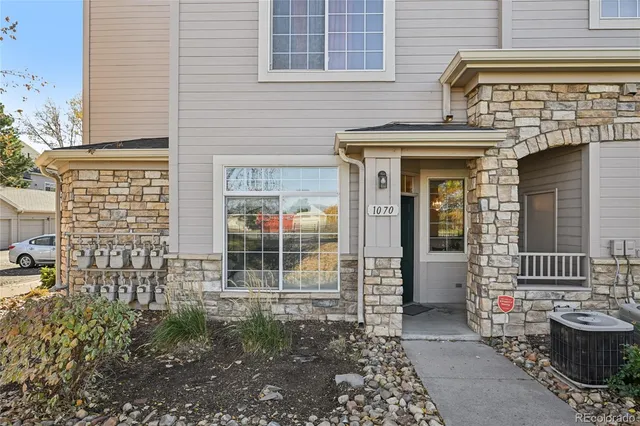 front view of a brick house with large windows