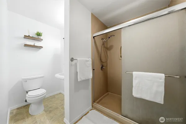 a bathroom with a toilet and a shower