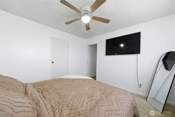 a bedroom with a bed and a flat screen tv