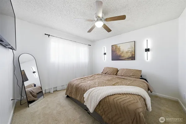 a bed sitting in a bedroom next to a window