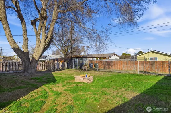 a backyard of a house with table and chairs
