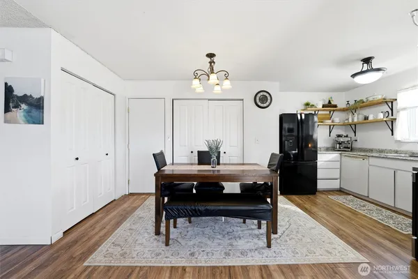 a view of a center kitchen island dining table wooden floor and a window