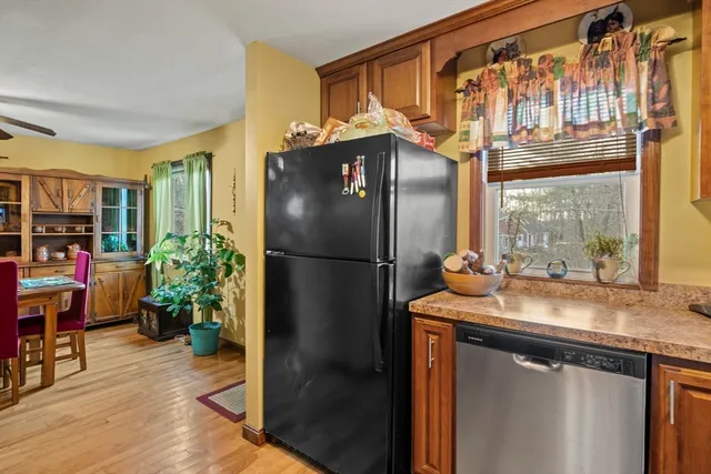 a kitchen with stainless steel appliances granite countertop a refrigerator and a sink