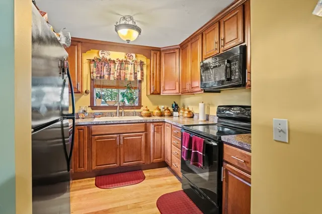 a kitchen with stainless steel appliances granite countertop a stove a sink and a refrigerator