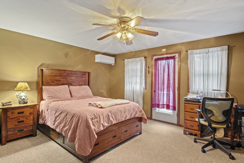 4 Wilson Way Rutland, MA 01543 - Photo 17 of 32 a bedroom with a bed and a chandelier