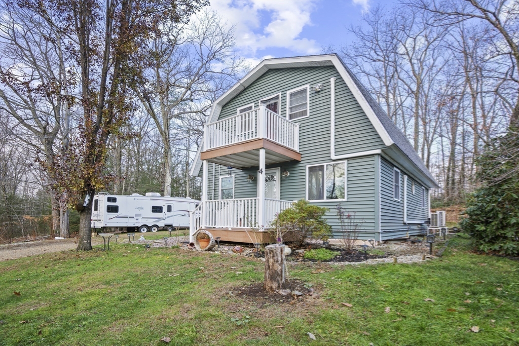 4 Wilson Way Rutland, MA 01543 - Photo 25 of 32 a front view of a house with a yard table and chairs