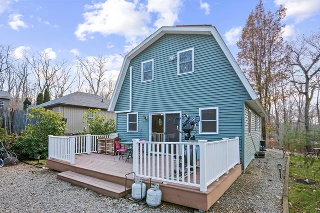 a view of a house with a yard and trees