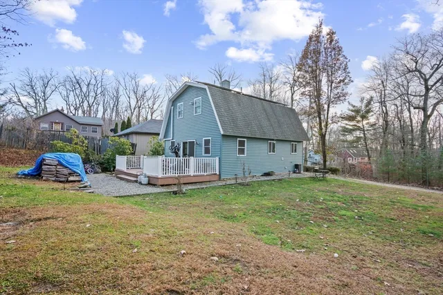 a view of a house with a yard and sitting area