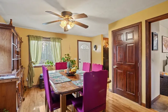 a view of a dining room with furniture and a chandelier