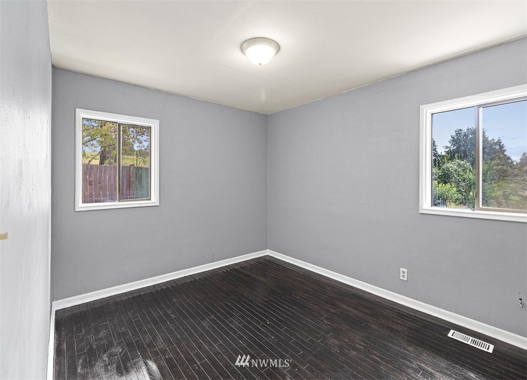 2619 Northeast 9th Street Renton, WA 98056 - Photo 14 of 25 a view of an empty room with wooden floor and a window