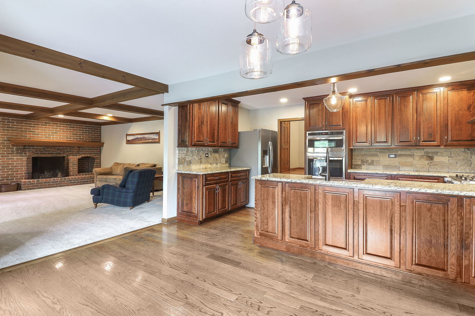841 Turnbridge Circle Naperville, IL 60540 - Photo 11 of 39 a kitchen with stainless steel appliances kitchen island granite countertop a refrigerator oven a sink dishwasher and white cabinets with wooden floor