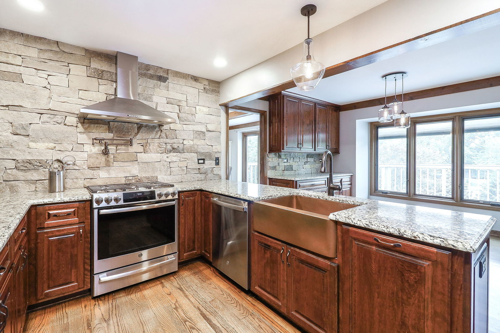 841 Turnbridge Circle Naperville, IL 60540 - Photo 9 of 39 a kitchen with stainless steel appliances granite countertop wooden cabinets stove and sink