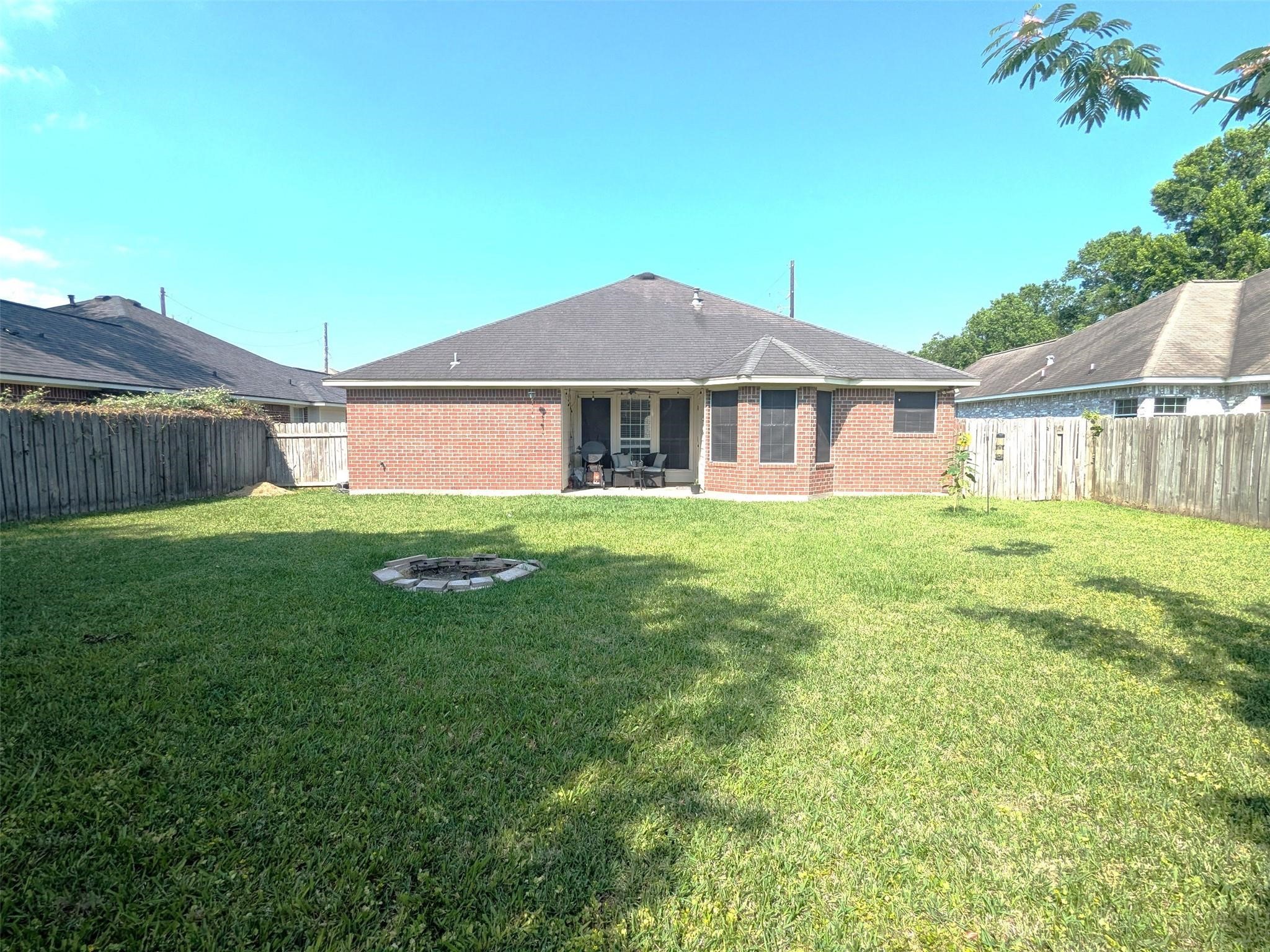 1035 North Colbert Street Dayton, TX 77535 - Photo 15 of 17 Large fenced in back yard with fire pit.
