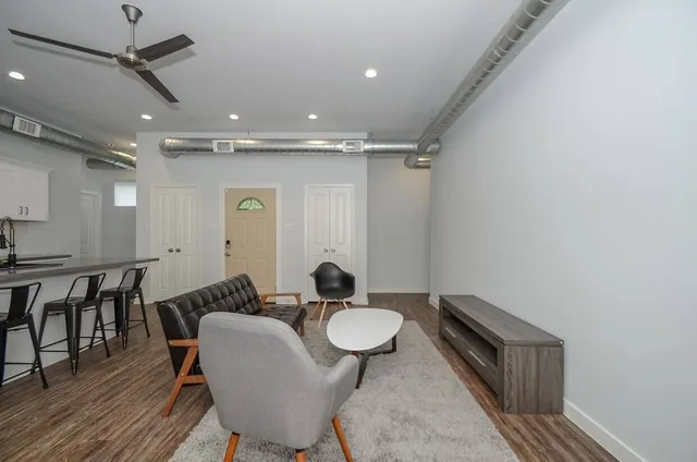 a dinning room with furniture and wooden floor